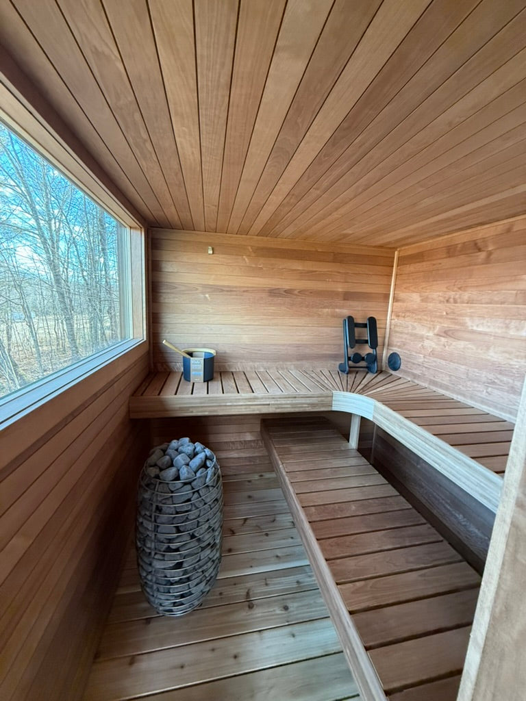 Searsmont, Maine custom sauna — tiered benches wrapping the hot room, heater under the window