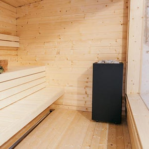 HUUM CORE black steel sauna heater in a finished sauna room