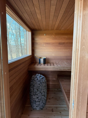 Searsmont, Maine custom sauna — hot room with HUUM HIVE Mini heater beneath the window and tiered benches