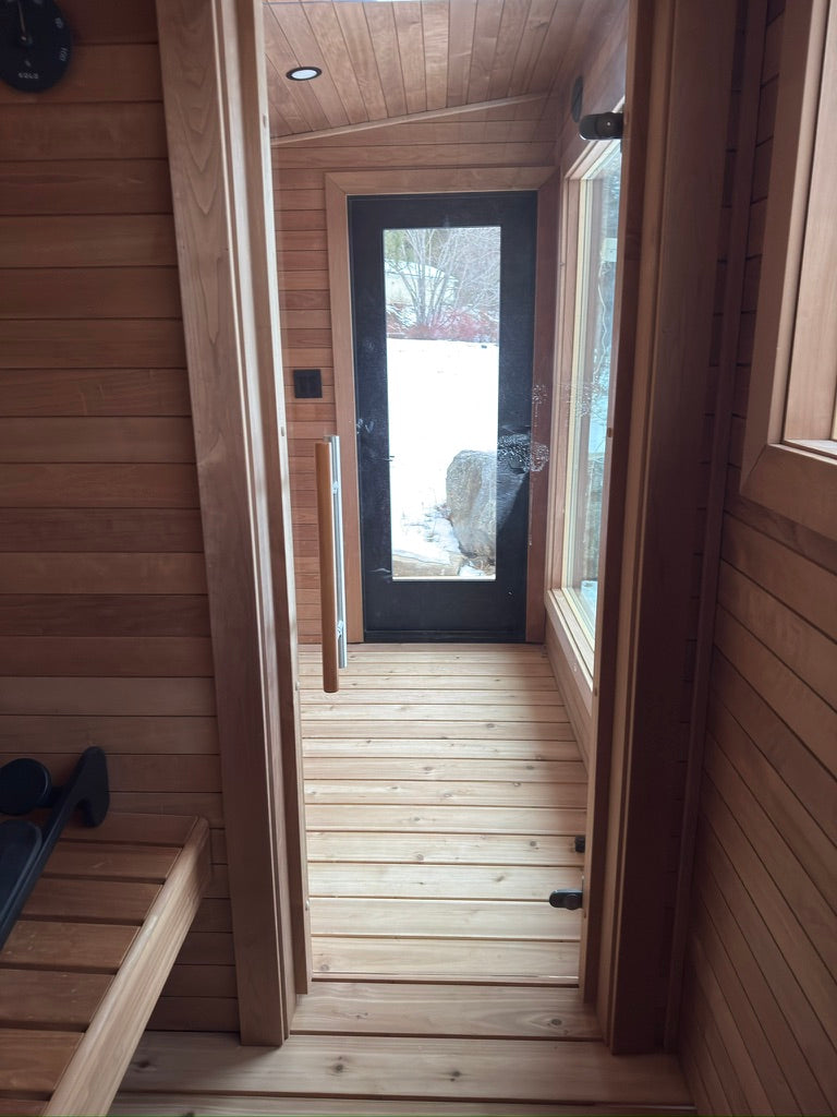 Searsmont, Maine custom sauna — looking from the hot room through the changing room to the glass entry door