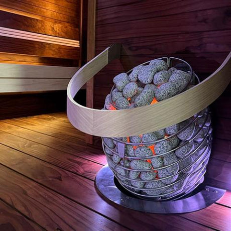 HUUM DROP sauna heater with the heating elements glowing through the stones