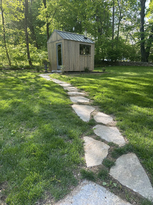 Wilton, Connecticut custom sauna — granite stepping-stone path leading across the lawn to the sauna door